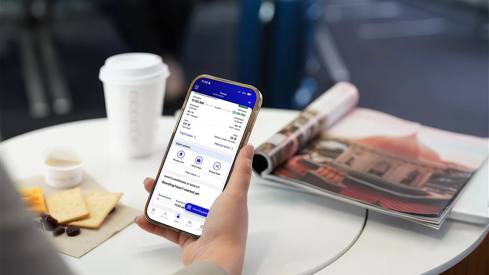 A traveler checking their flight status on the United app